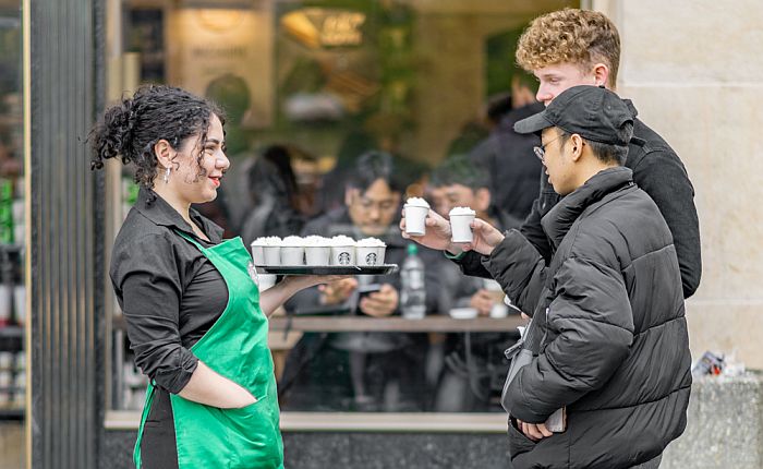 Starbucks crew with cups of their products