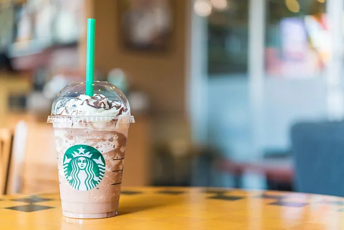 A cup of Frappuccino coffee on a table.